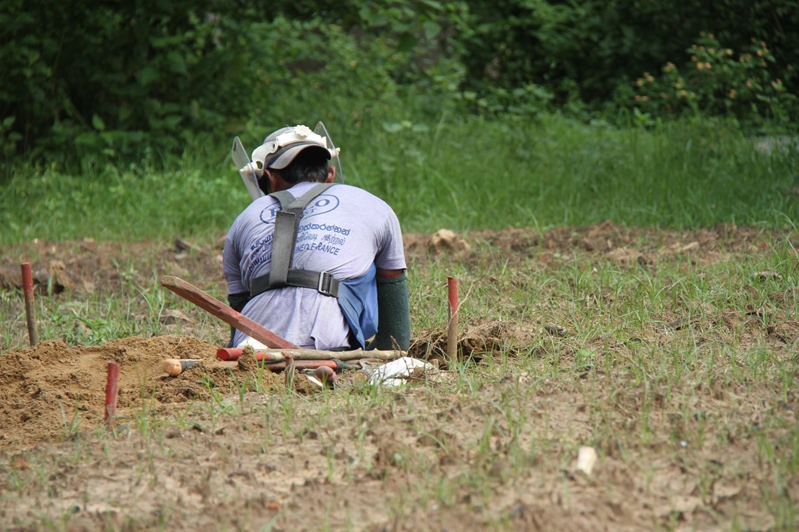 A deminer works in the Geevarasa family garden, Sri Lanka, HALO Trust
