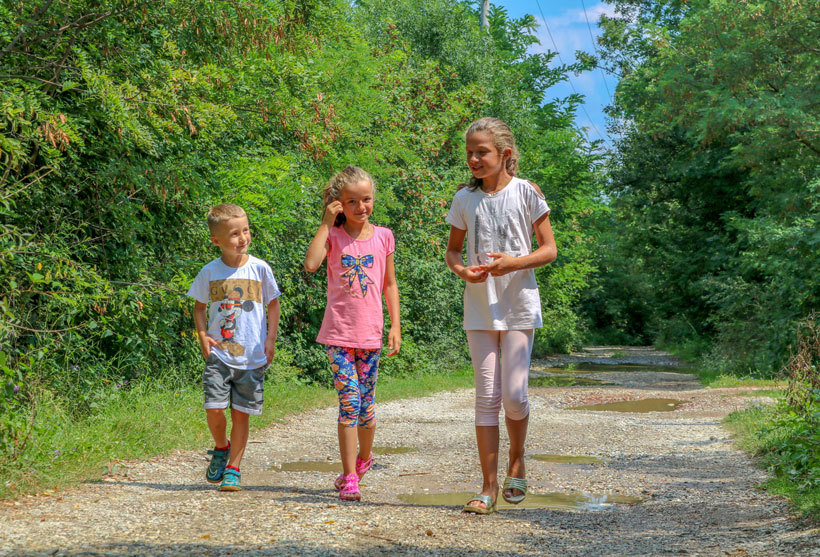 In Kryshec, children walk on a path to school