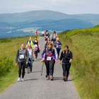 A group participating in the "walk for Syria" event walk through a path in the countryside