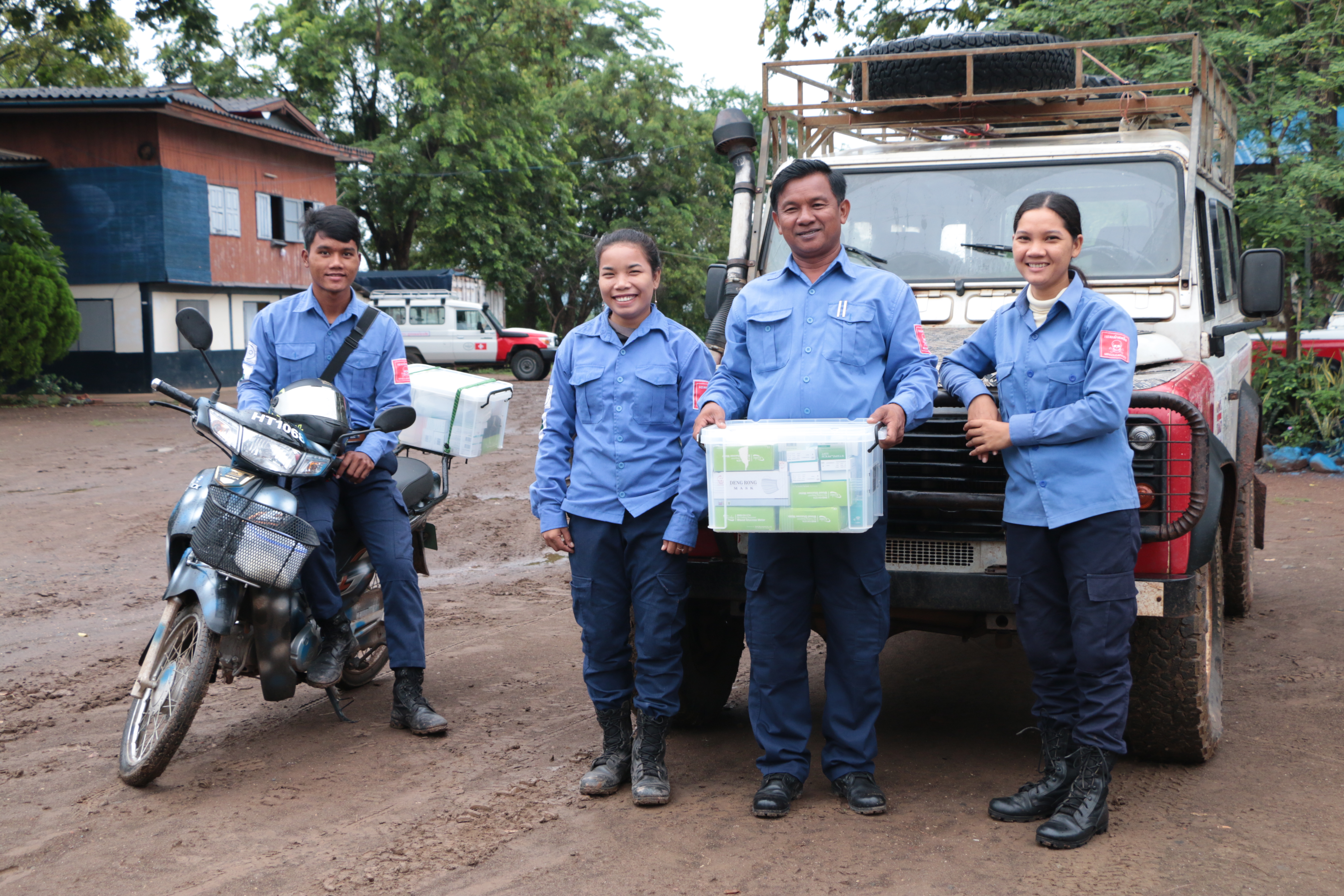 Group of HALO staff in front of a truck carrying emergency supplies