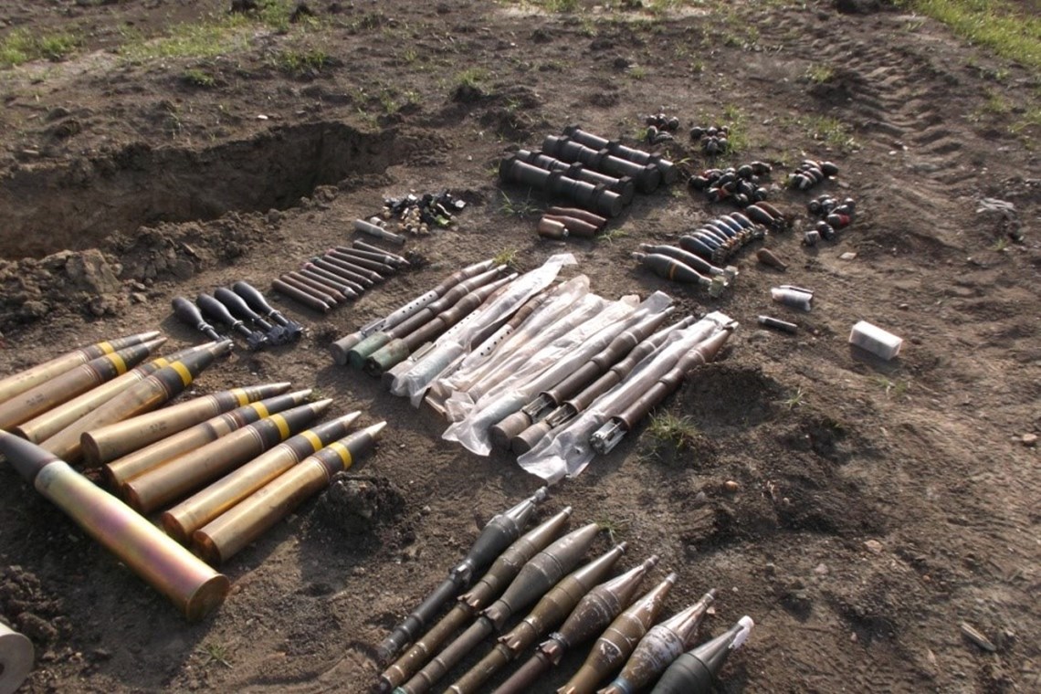 Various types of ammunition adjacent to the demolition 'pit', into which they will be arranged to give optimum effect during the demolition, HALO Trust.