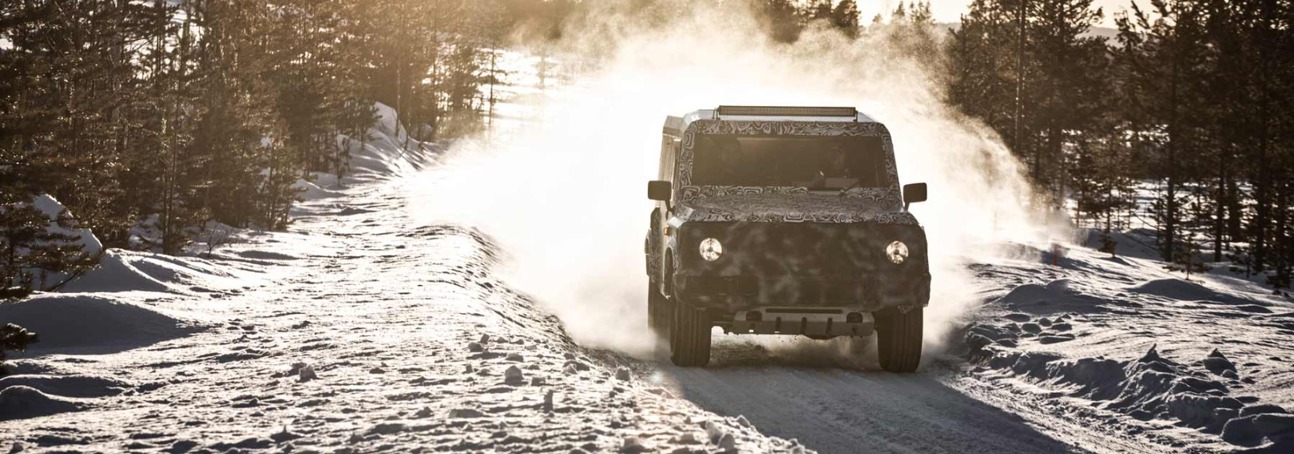 A Grenadier 4x4 vehicle driving through snow