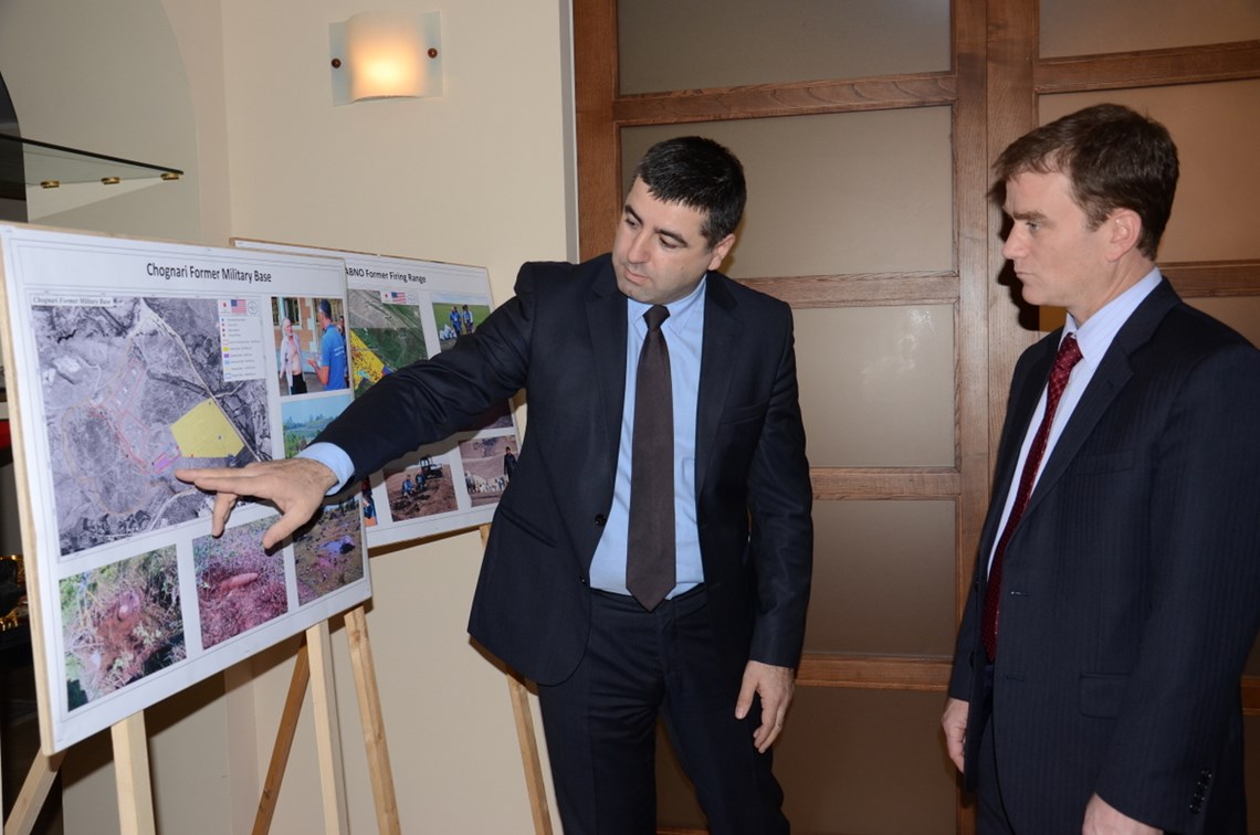 HALO Georgia programme manager, Irakli Chitanava shows the military base on the map to Nicholas Berliner Deputy Head of Mission US Embassy. 