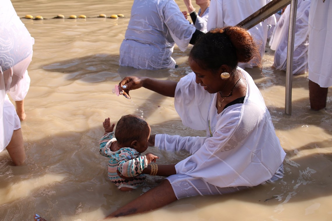 Child being baptised in the River Jordan, Baptism site