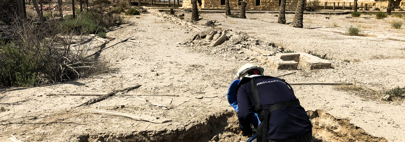 A deminer carries out demining activities on a compound at the Baptism Site
