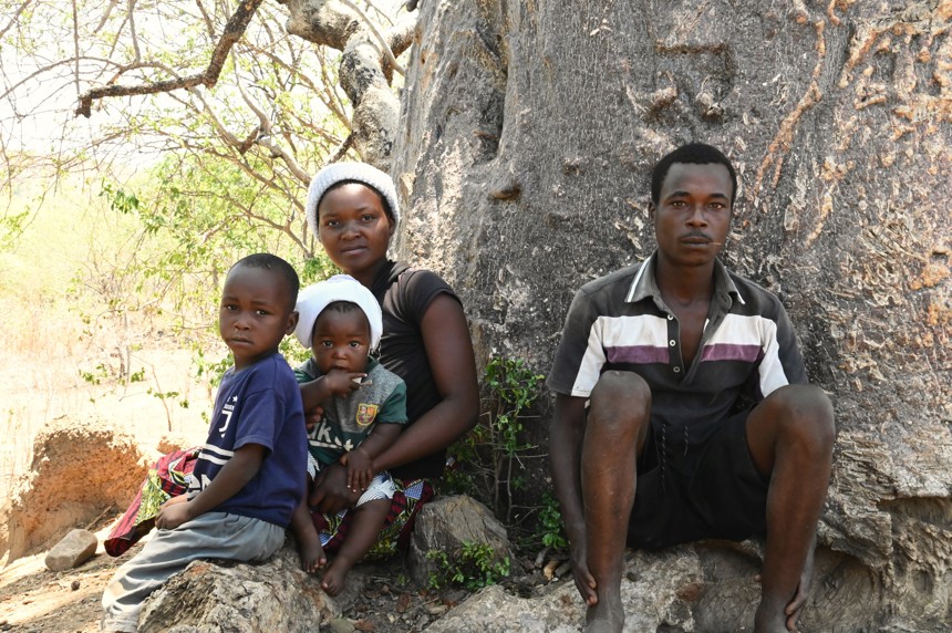A family sitting under a tree in Zimbabwe