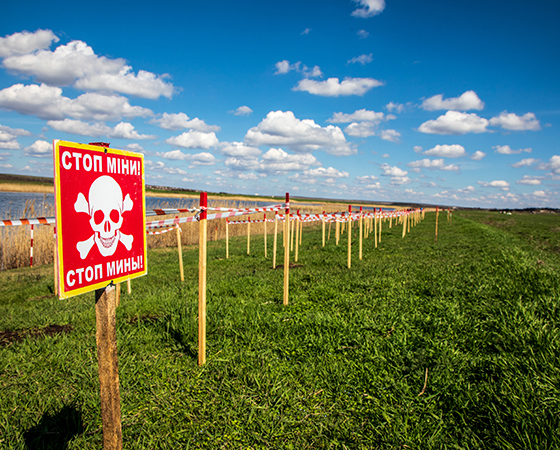 A minefield in Mykolaiv oblast is lined with mine warning signs
