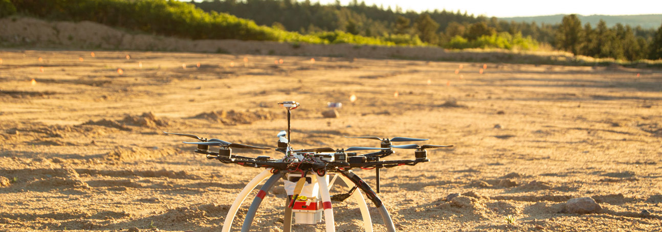 A drone used to identify mines and other explosive ordnance on the sandy soil of a minefield
