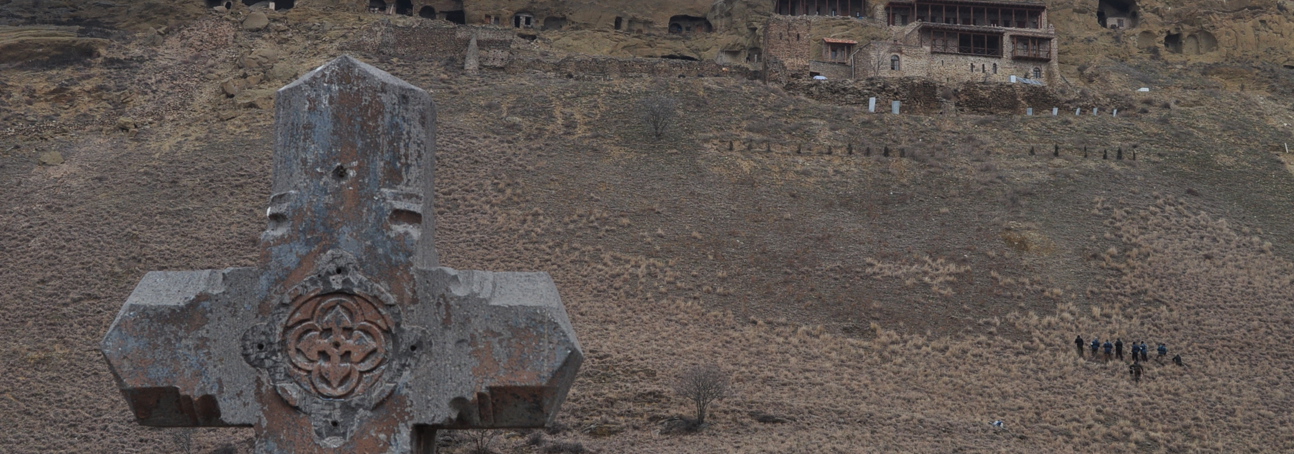 Close-up of a grave stone in front of a Georgian monastery