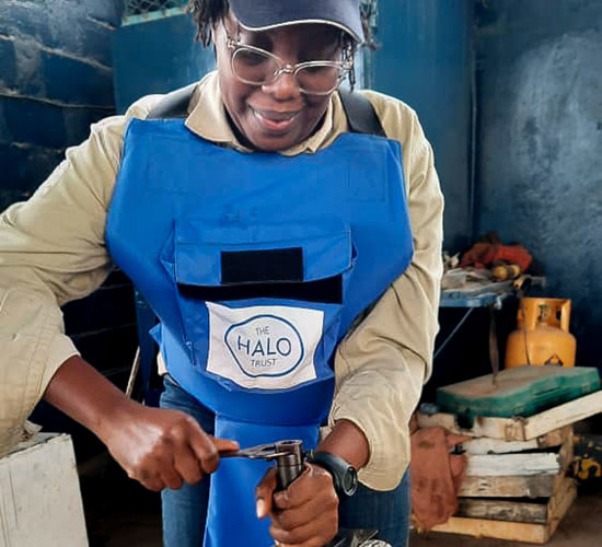 Jessica uses a spanner during training wearing HALO PPE