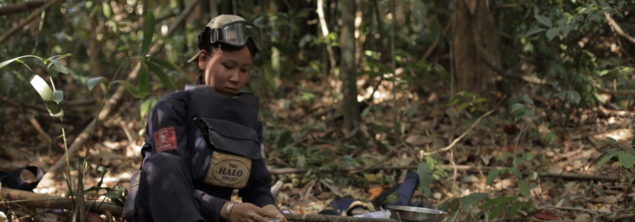A HALO deminer sits in the jungle with their demining equipment