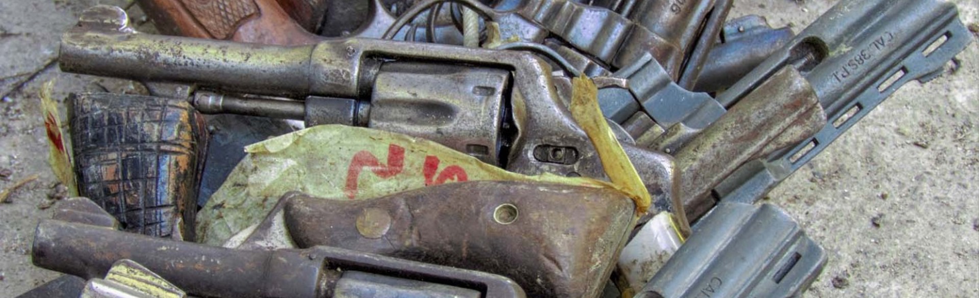 A pile of old weapons lay on the ground