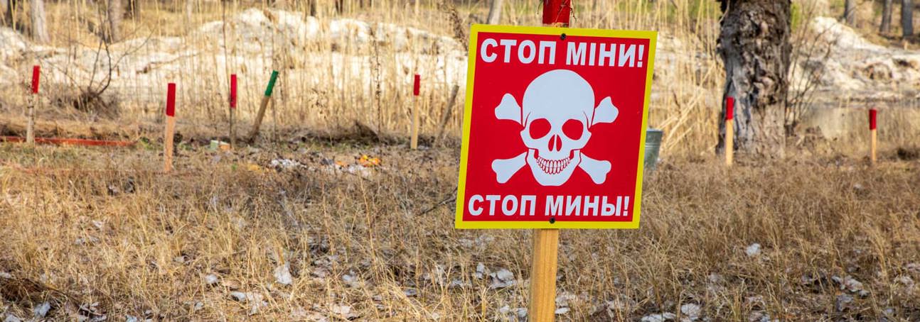 A red danger sign in Pechenihy Minefield in Kharkiv Oblast in Ukraine