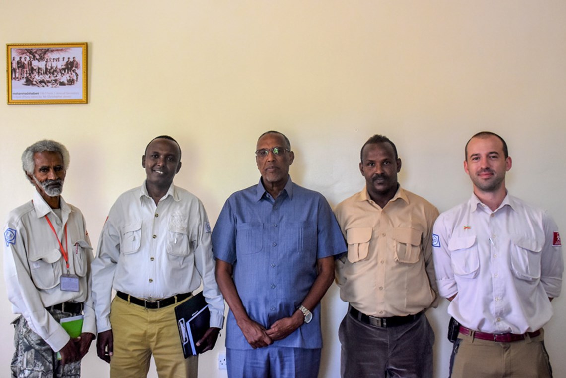 Senior HALO staff meet H.E. President Muse Bihi Abdi in recognition of their work on the Geed Deeble site