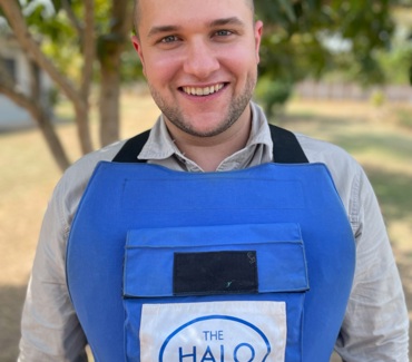 Man smiling, wearing a HALO vest