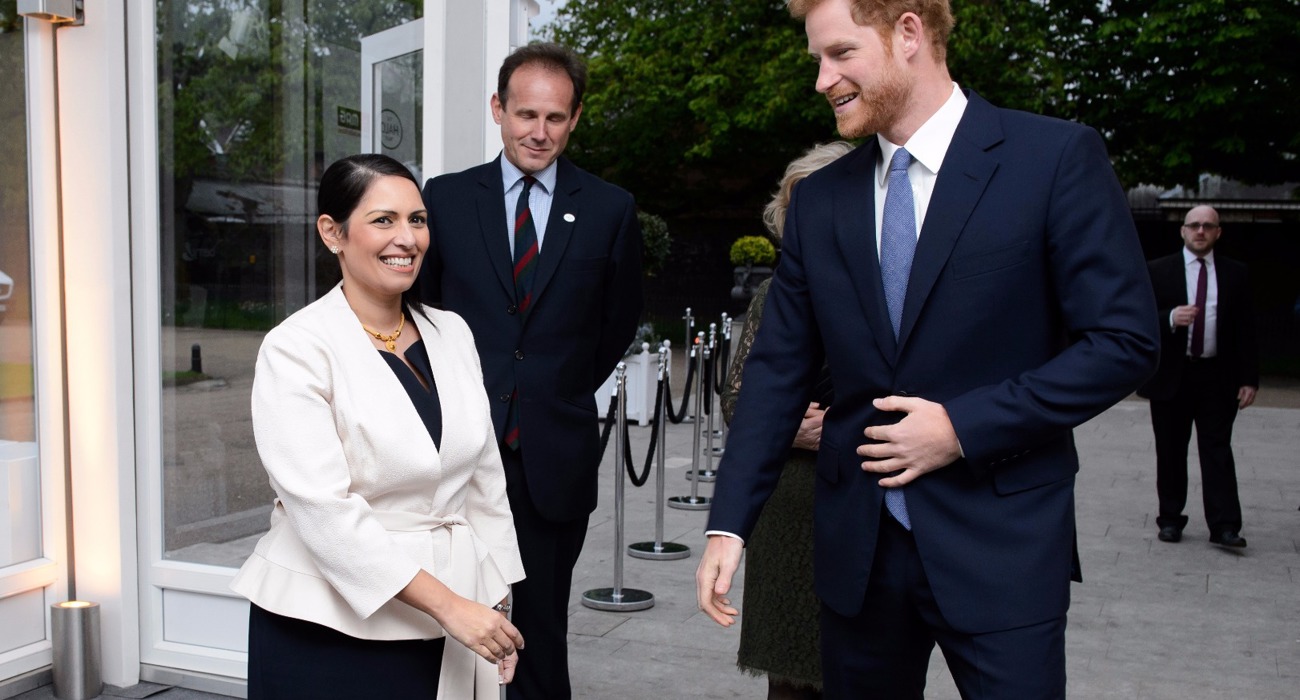 Former Secretary of State for International Development, Priti Patel talks with Prince Harry