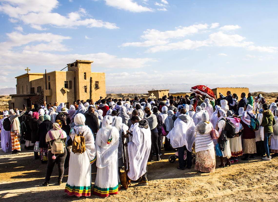 Ethiopian pilgrims gather outside their mined church for Epiphany
