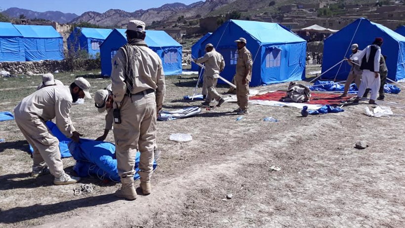 Demining teams erect tents for shelter and field hospitals