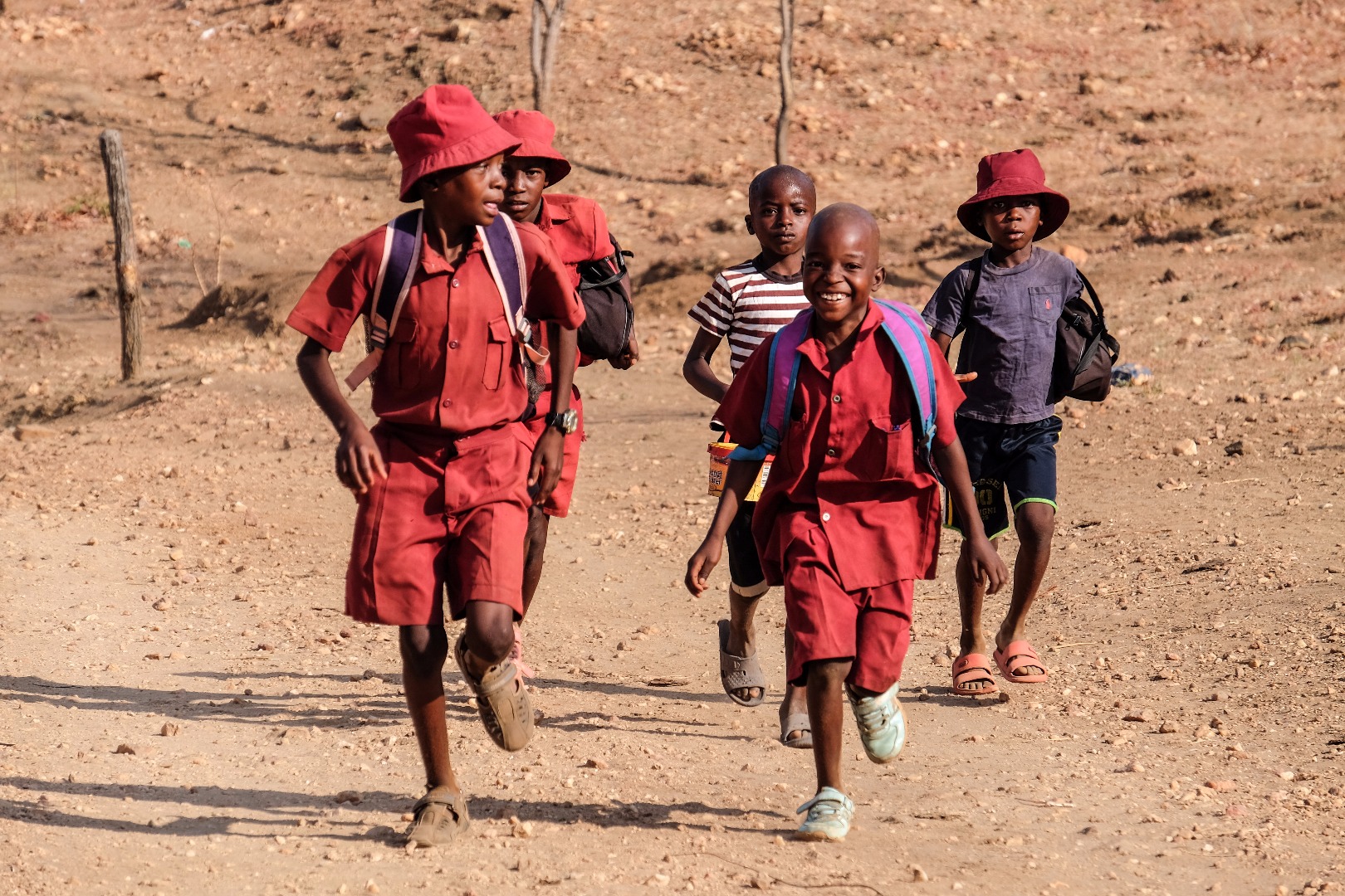 School kids walk through a rural area in Zimbabwe