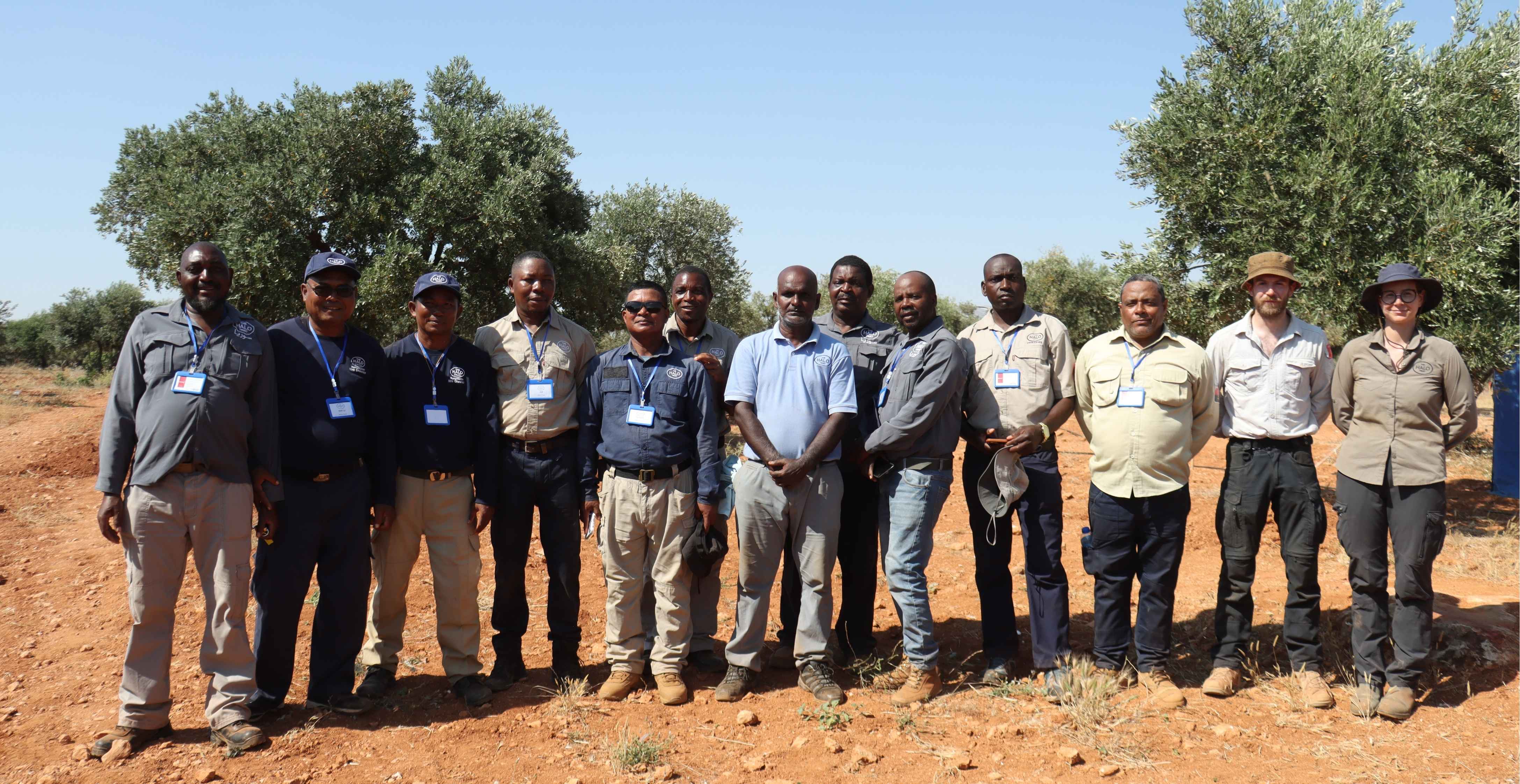 Group of international deminers smiling for the camera in Idlib, Syria