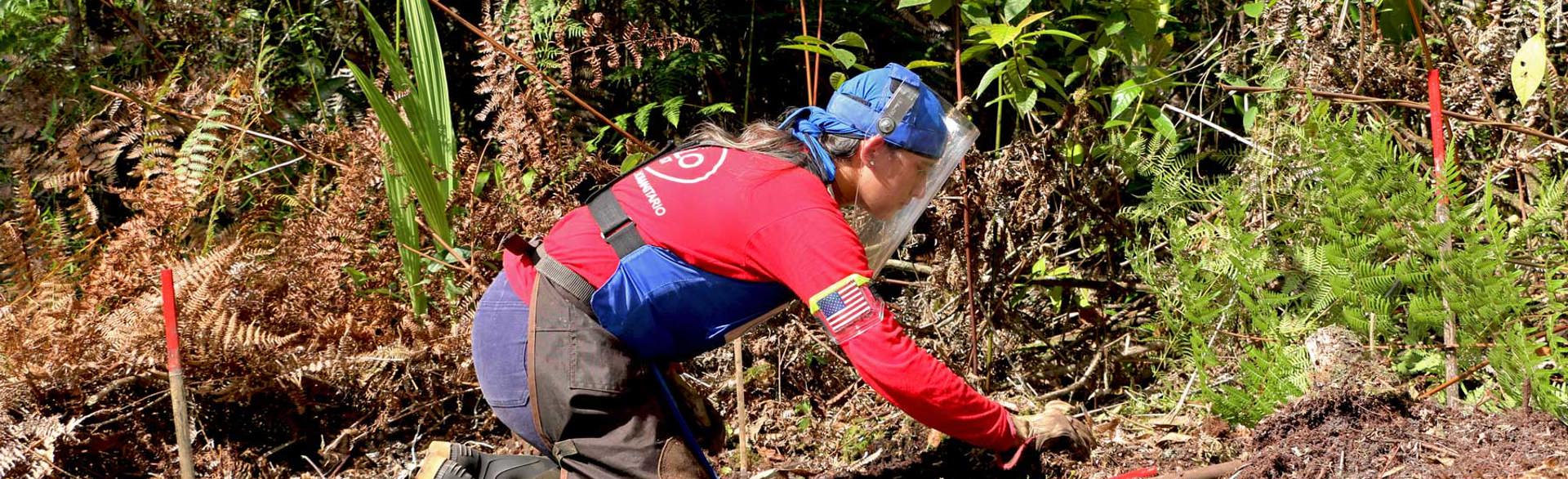 Katerine Ramirez, a HALO staff member carries out demining activities on the ground