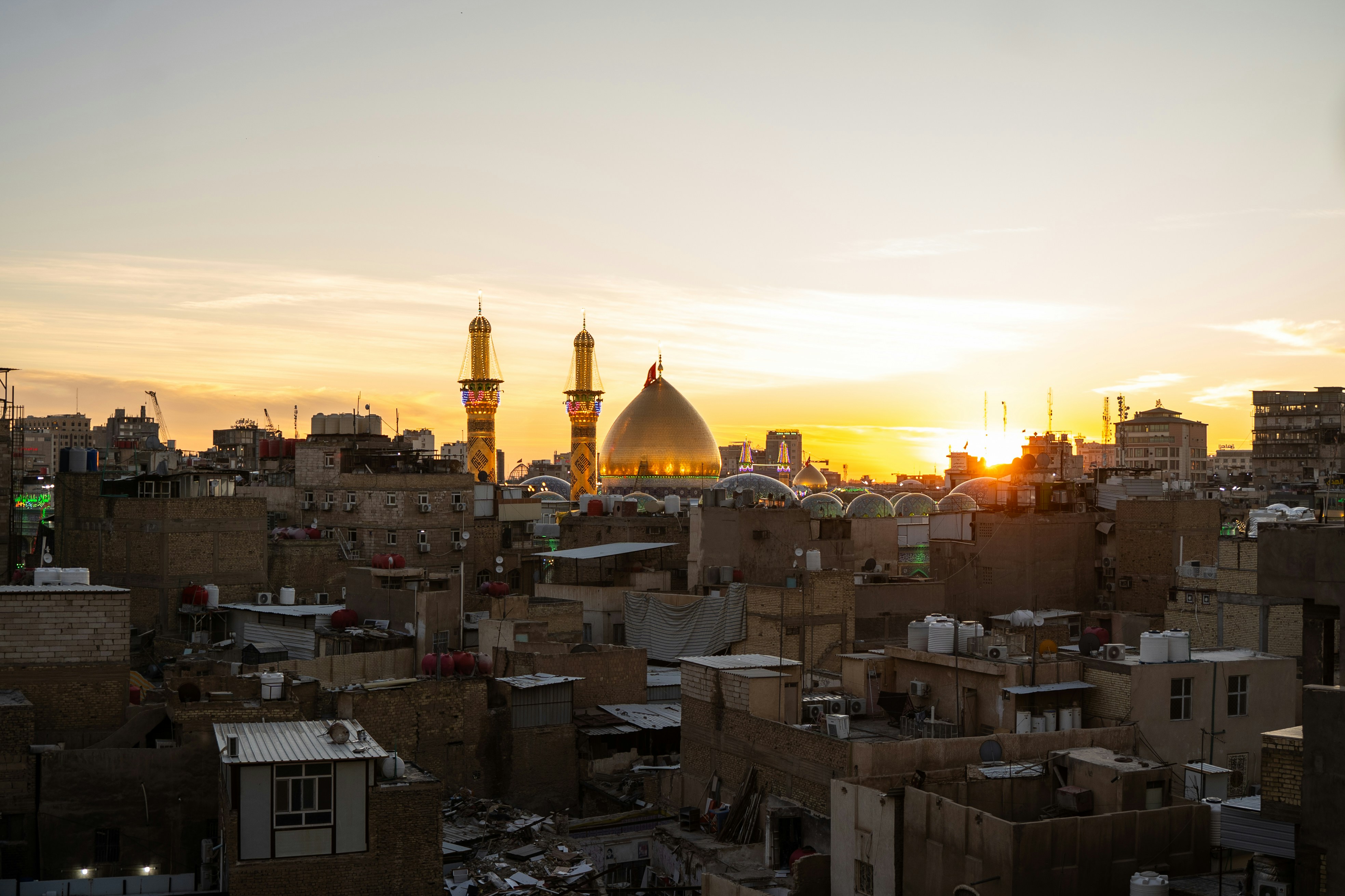 Sunset over rooftops of Iraqi city