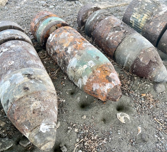 A collection of rusted US six-inch practice projectiles