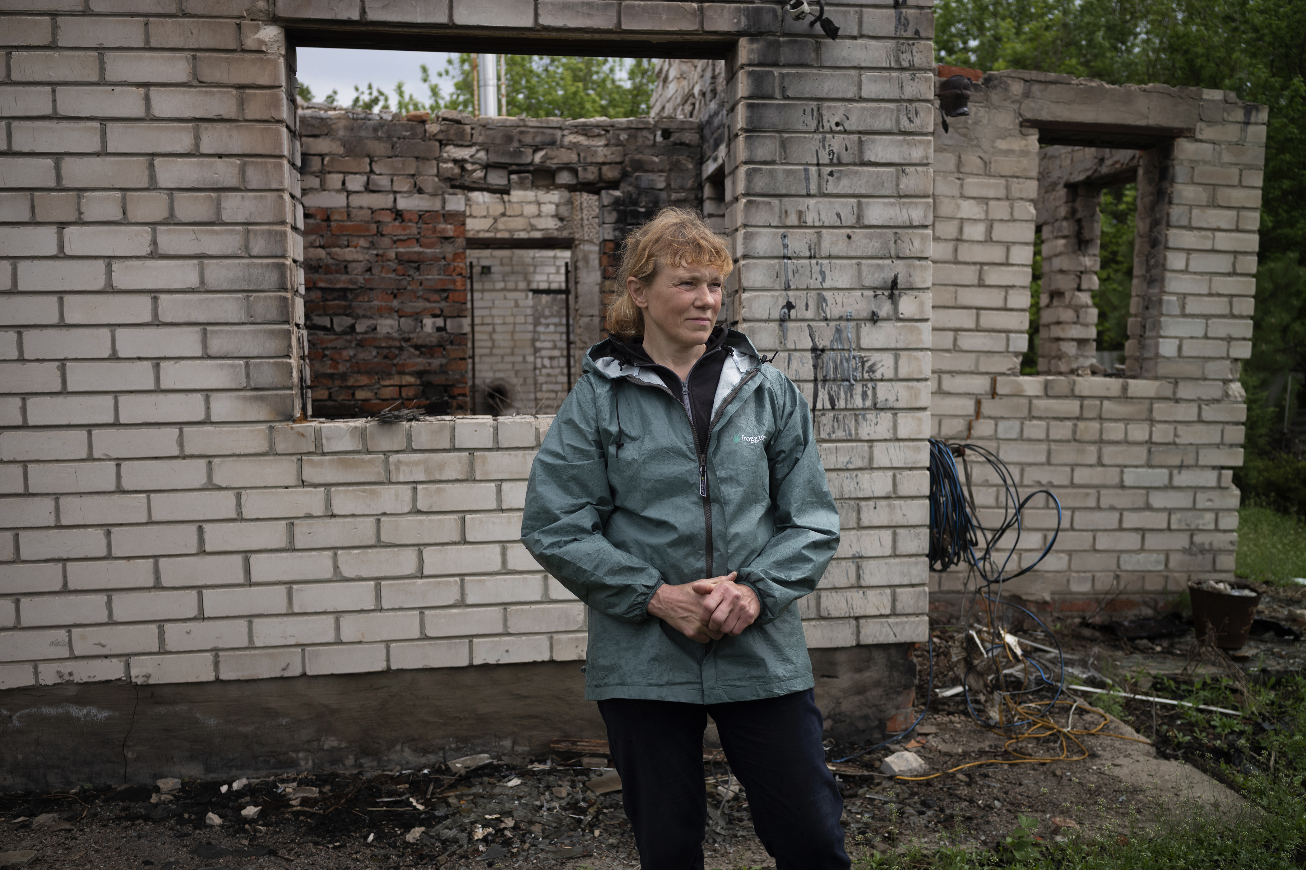 Natalia stands before the remains of her family’s home.