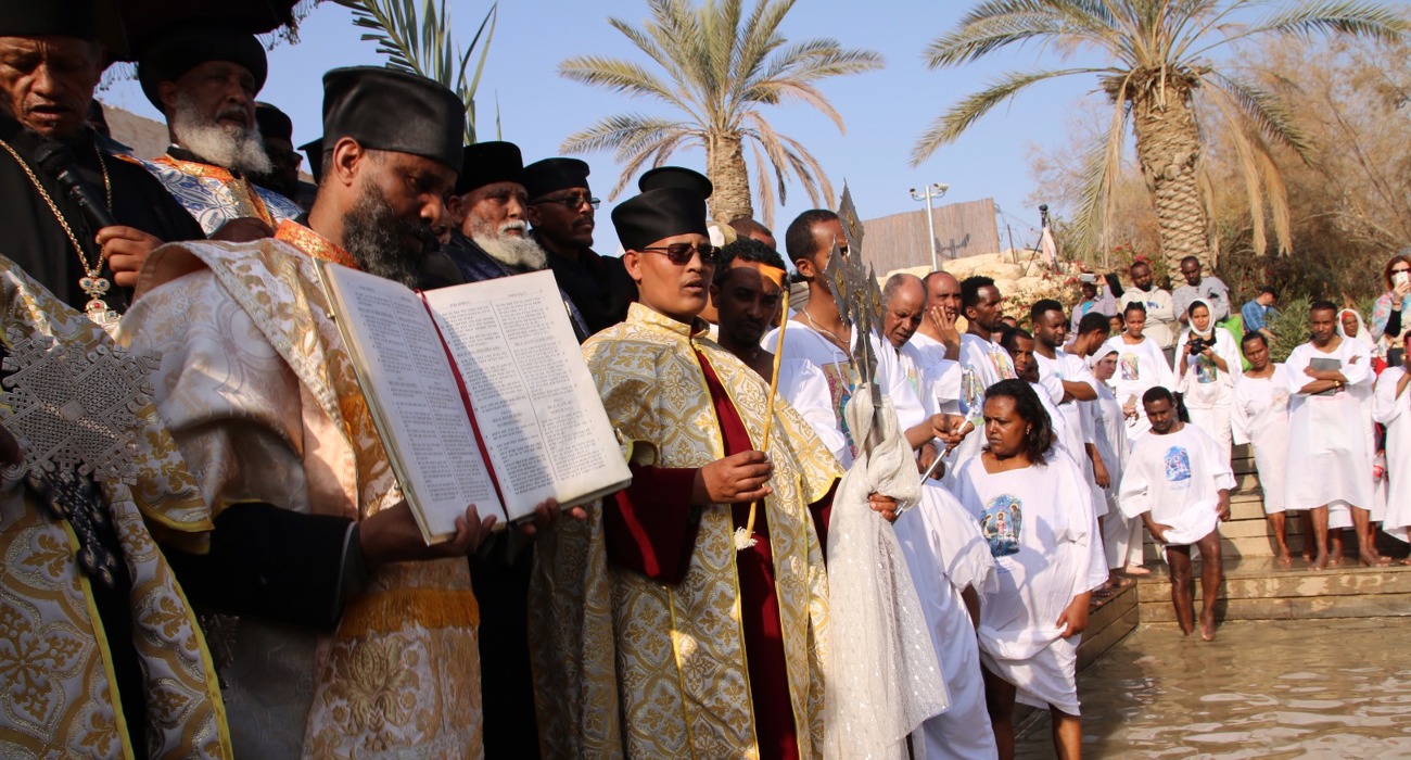 Clergy lead a solemn procession during the epiphany service at the Baptism site, dressed in traditional robes.