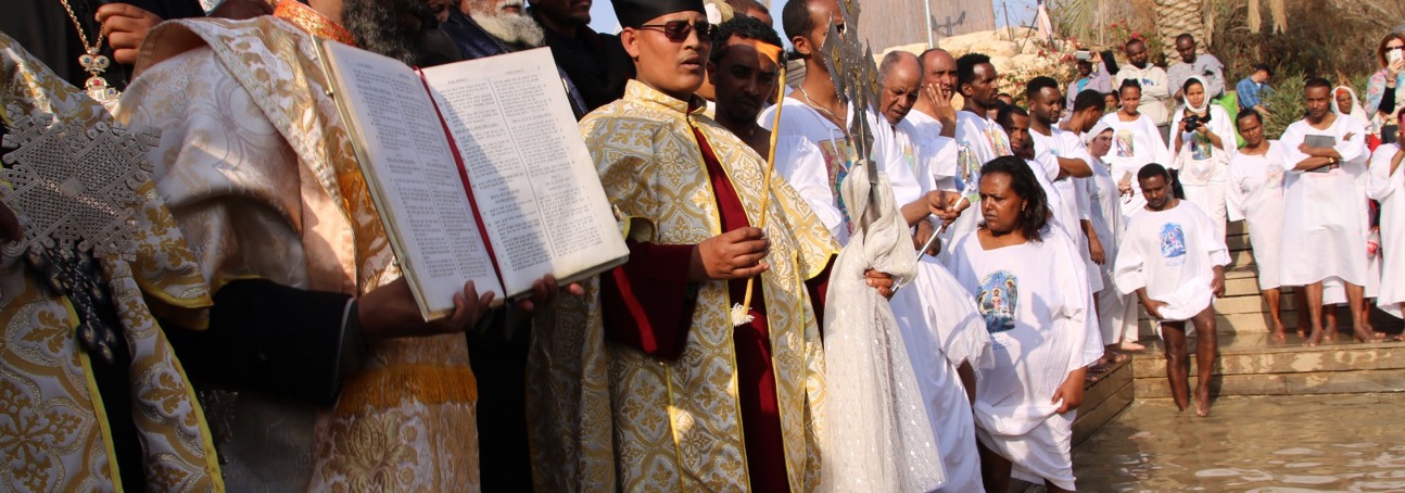 Clergy lead a solemn procession during the epiphany service at the Baptism site, dressed in traditional robes.