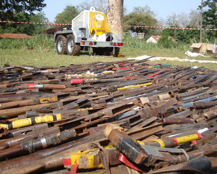 Old rusty weapons lay on grassy ground