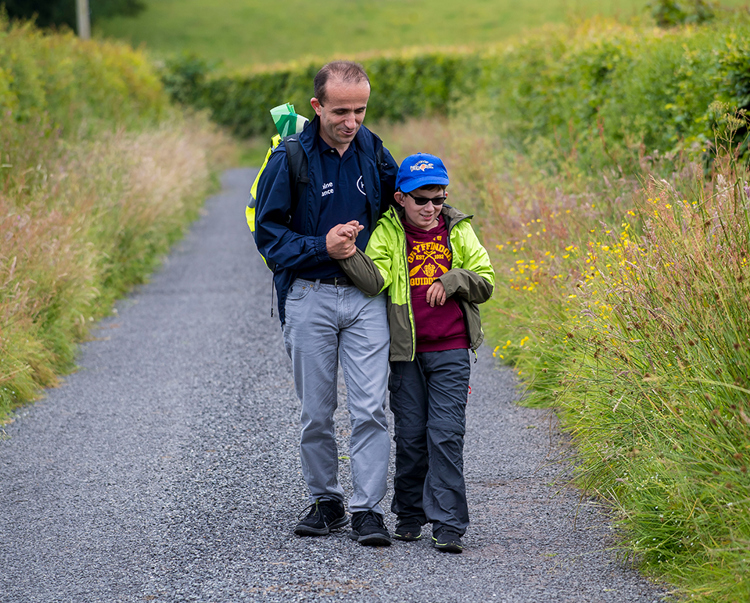 HALO's Head of ICT, Luan Jaupi and his son walk for Syria down a country path