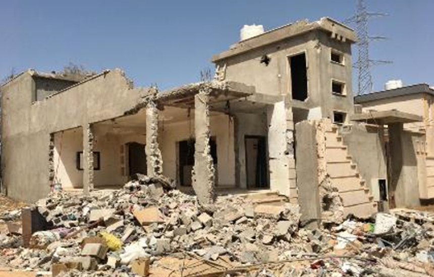 A destroyed building surrounded by rubble in Sirte, Libya
