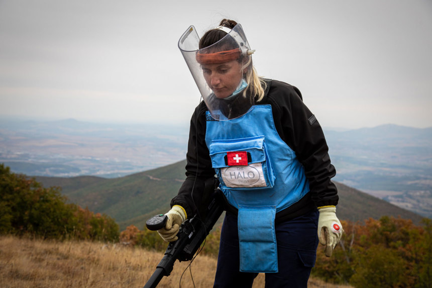 A HALO deminer uses a detector in the hills in Kosovo