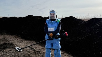 HALO deminer holding a detector