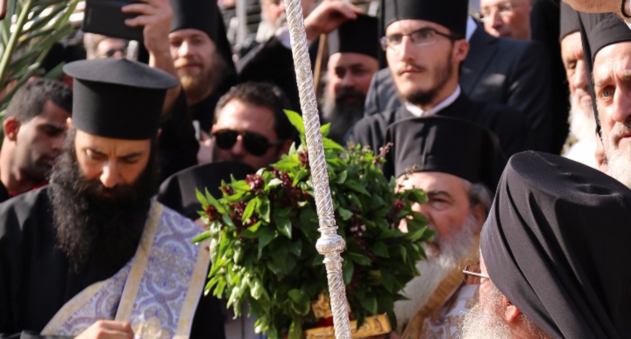 Clergy lead a solemn procession during the epiphany service at the Baptism site, dressed in traditional robes.