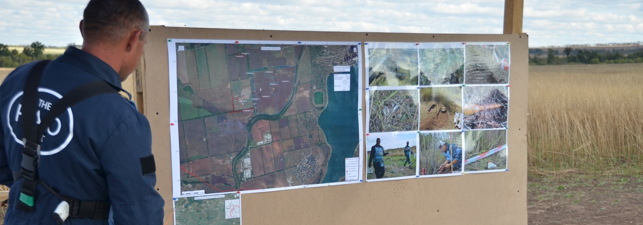 HALO staff member looks at a task map on a minefield in Ukraine