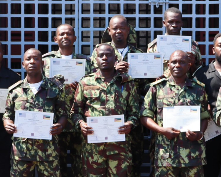 14 security personnel trained in weapons and ammunition management pose with their certificates 