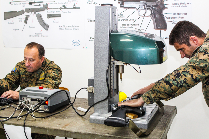 two men mark weapons in Bosnia Herzegovina