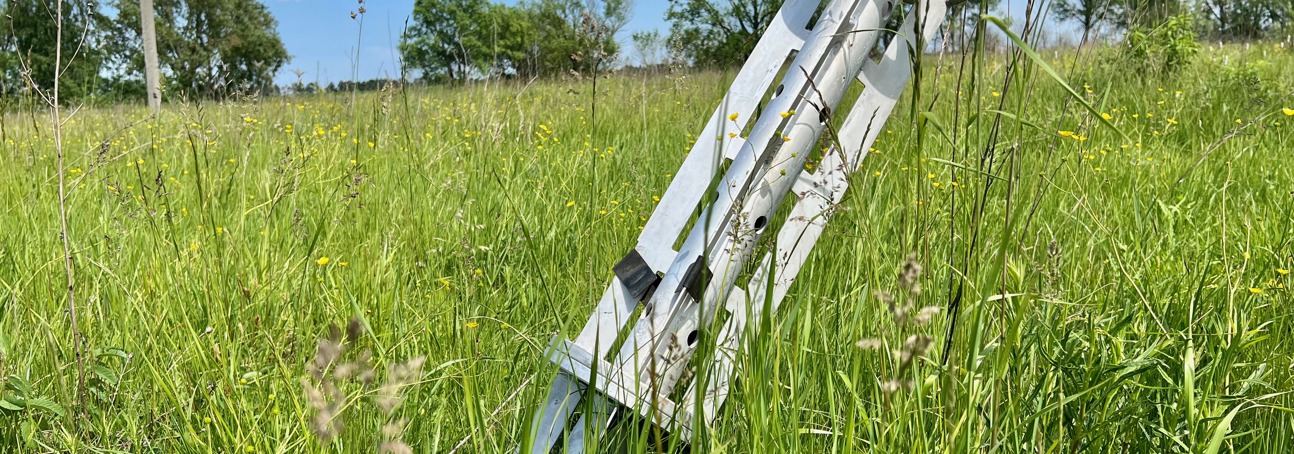 A large piece of metal stuck out of the ground in a field in Ukraine