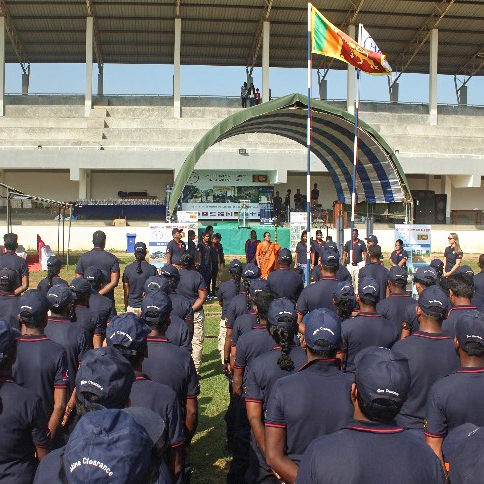 HALO staff members stand at a mine clearance ceremony in Sri Lanka