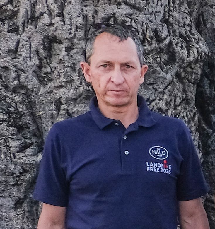 Tom Dibb, a Project Manager at HALO, looks into the camera wearing a HALO branded top
