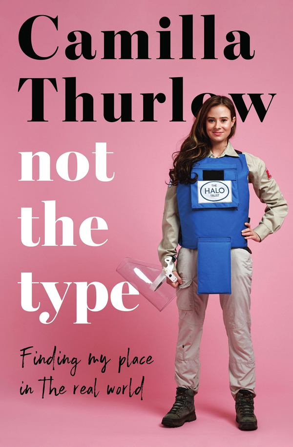 Camilla Thurlow stands in HALO branded PPE against a pink backdrop on the cover of her autobiography