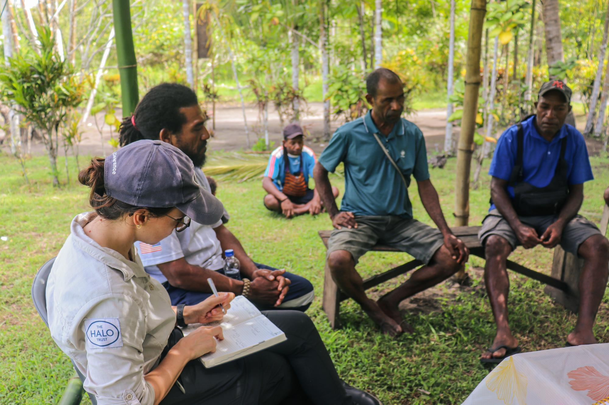 HALO staff meet with community members to conduct survey of UXO