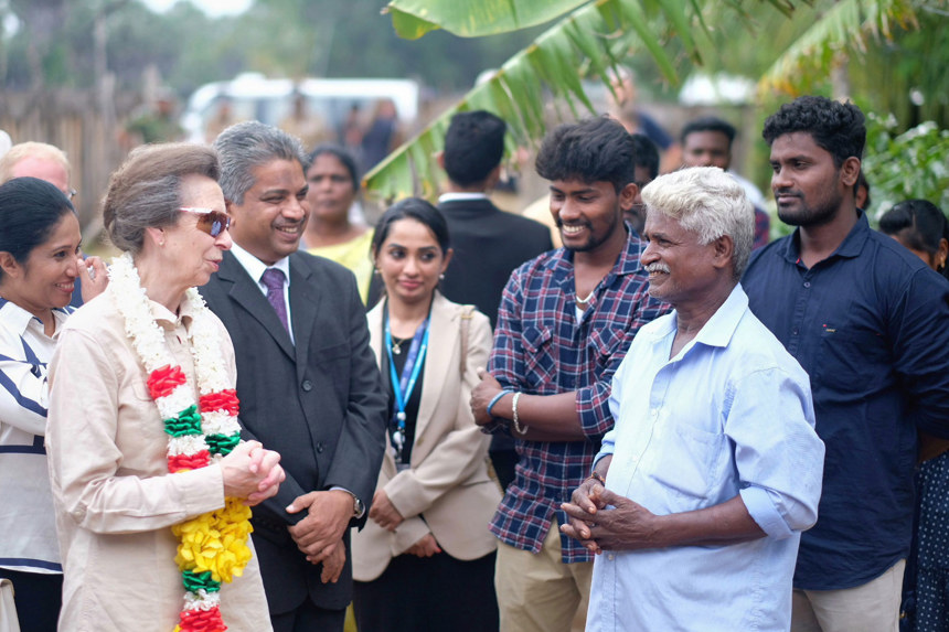 HRH Princess Anne greets HALO Trust staff and delegates whilst wearing a flower garland in Sri Lanka