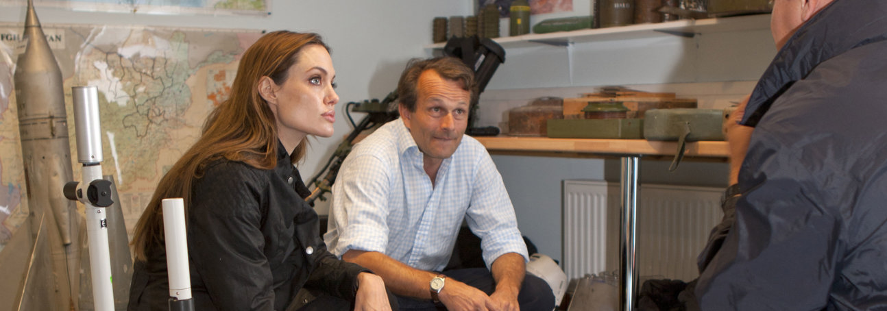 Angelina Jolie and Guy Willoughby crouch amongst explosives at HALO's HQ in Scotland