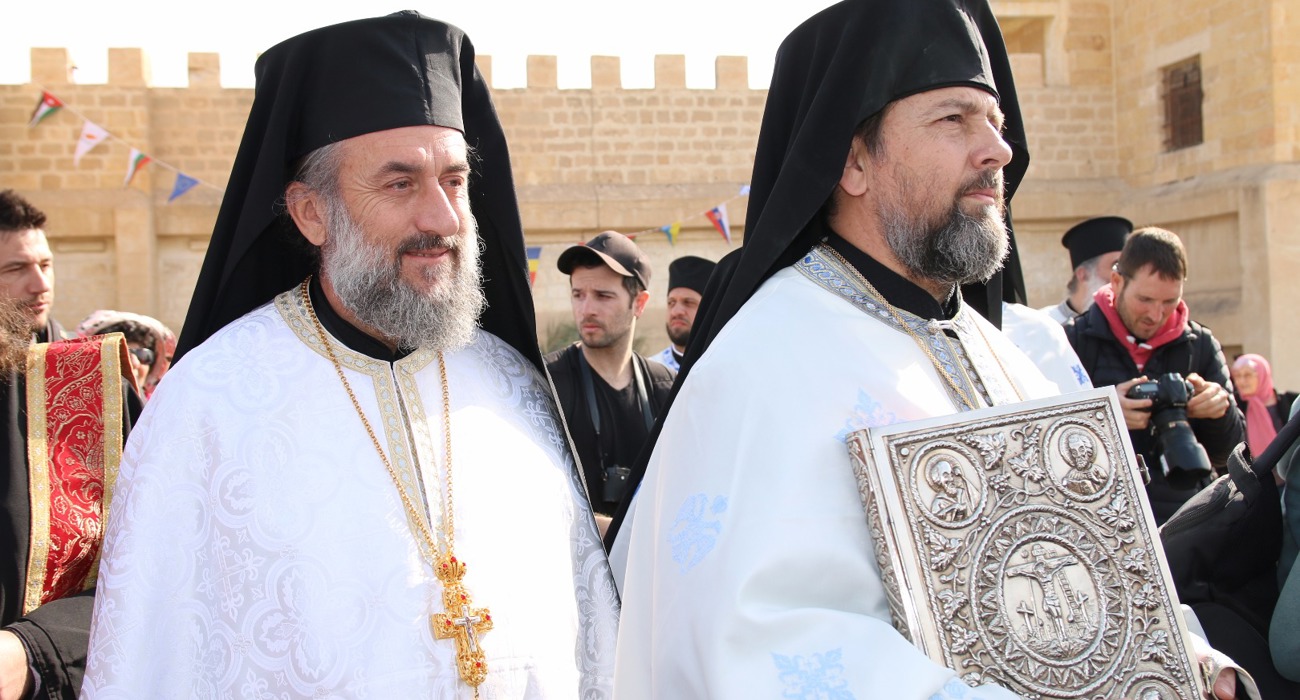 Clergy lead a solemn procession during the epiphany service at the Baptism site, dressed in traditional robes.