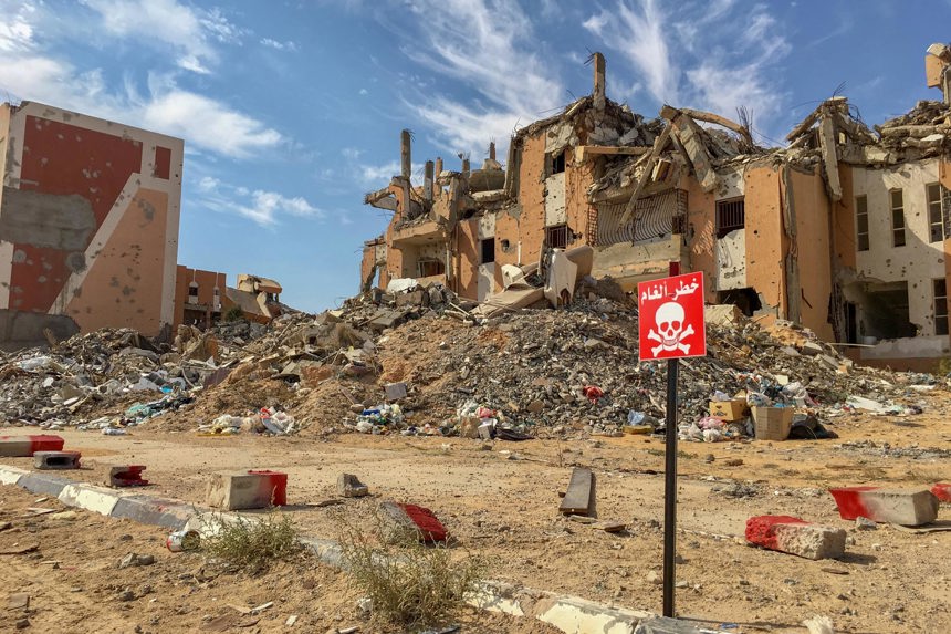 A house contaminated with explosives is marked off in Sirte, Libya