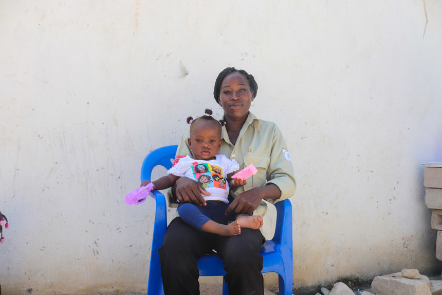 Florinda Baptista sits with her child in Angola