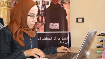 Nour Sheehan, Explosive Accident Support Worker sits in an office